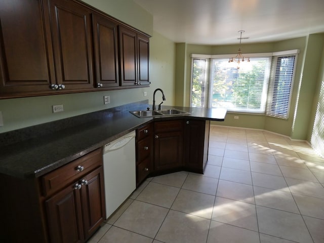 kitchen with decorative light fixtures, light tile patterned floors, sink, dishwasher, and kitchen peninsula