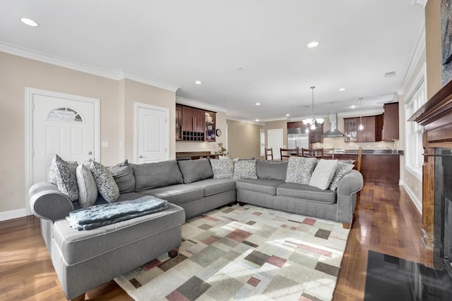 living area with recessed lighting, crown molding, baseboards, and wood finished floors