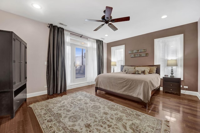 bedroom with dark wood-style floors, visible vents, baseboards, and recessed lighting