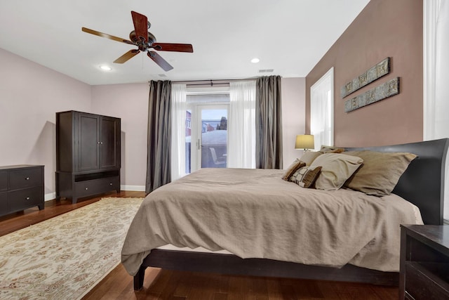 bedroom featuring access to exterior, recessed lighting, dark wood finished floors, and baseboards