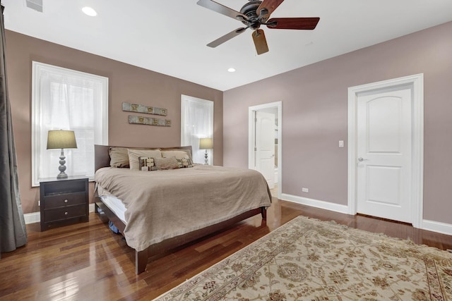 bedroom with recessed lighting, wood finished floors, and baseboards