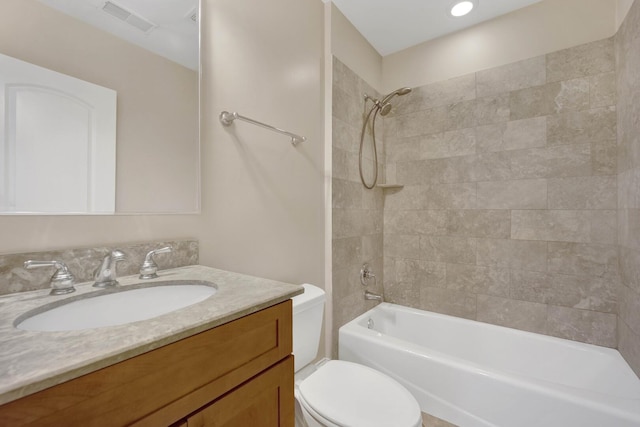 bathroom with toilet,  shower combination, vanity, and visible vents