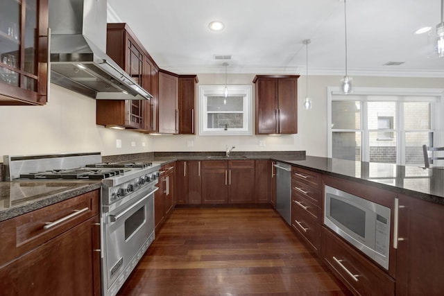 kitchen featuring dark wood-style floors, crown molding, stainless steel appliances, a sink, and wall chimney exhaust hood