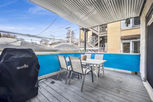 deck with outdoor dining space and a grill