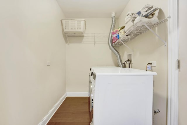 washroom with dark wood-style floors, laundry area, washer and clothes dryer, and baseboards