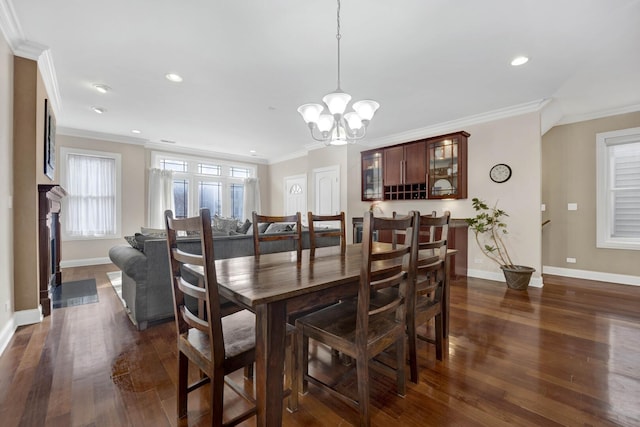 dining space featuring crown molding, baseboards, dark wood-type flooring, and recessed lighting