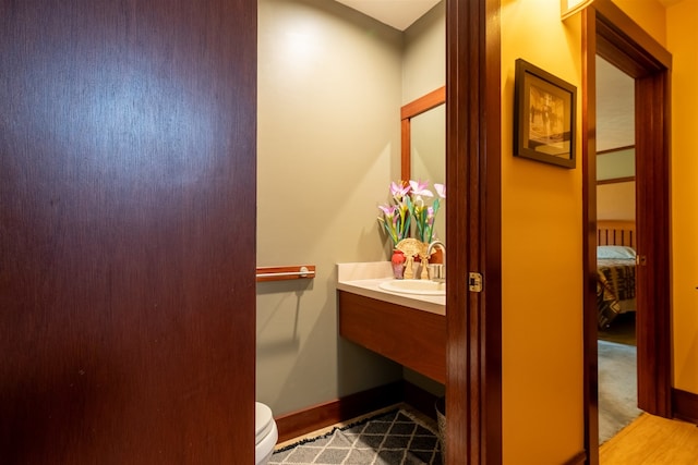 bathroom featuring hardwood / wood-style floors, toilet, and sink