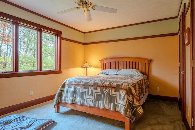 carpeted bedroom with ornamental molding and ceiling fan