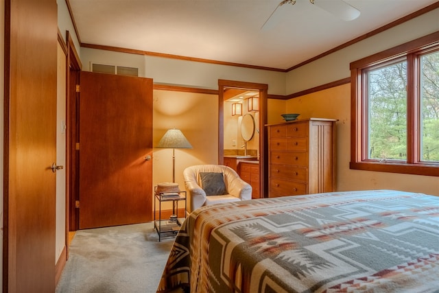 carpeted bedroom featuring ceiling fan, crown molding, and sink