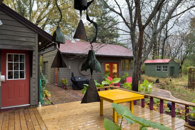 wooden terrace featuring a storage shed