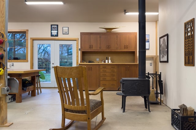 dining area with a wood stove and french doors