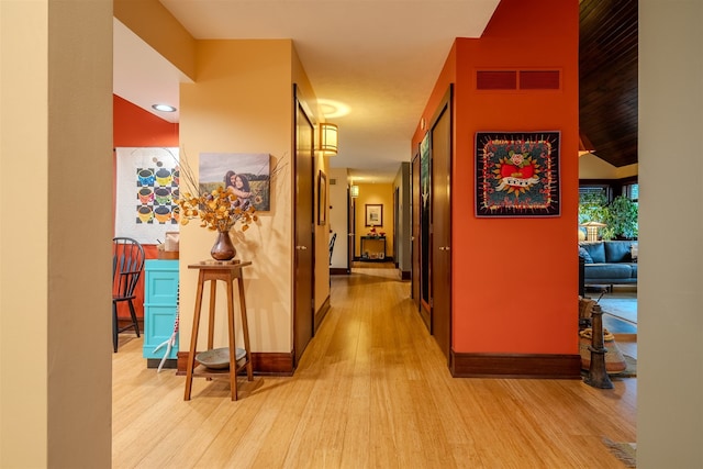 corridor with light hardwood / wood-style floors