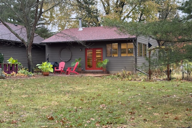 view of front of house with a front lawn and french doors