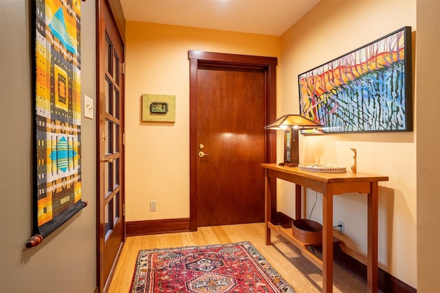 hallway with light hardwood / wood-style floors