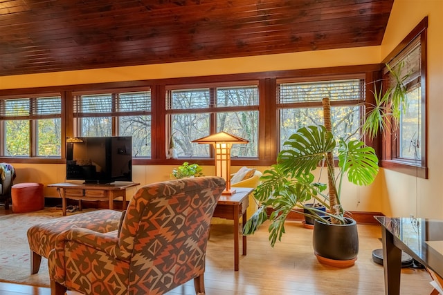 living room with light hardwood / wood-style floors, a healthy amount of sunlight, and wood ceiling