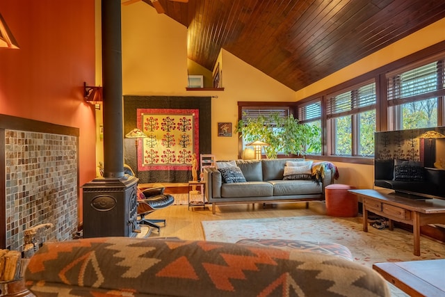 living room featuring wooden ceiling, a wood stove, and high vaulted ceiling