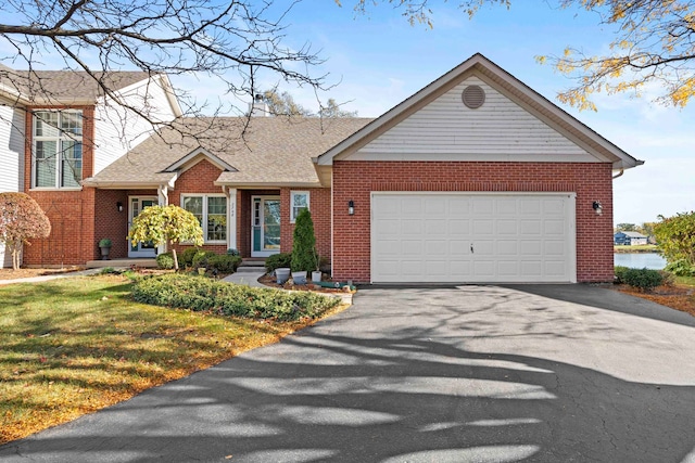 view of front of property featuring a garage and a front yard