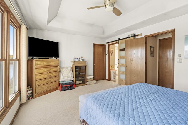 2708 Lake Shore Dr Unit 1, Joliet, IL 60431 - carpeted bedroom with a tray ceiling, a barn door, and a ceiling fan
