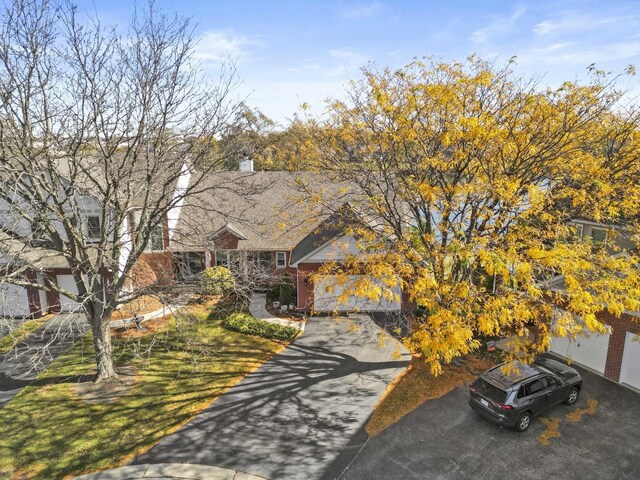 2708 Lake Shore Dr Unit 1, Joliet, IL 60431 - view of front of house featuring driveway, a chimney, and brick siding