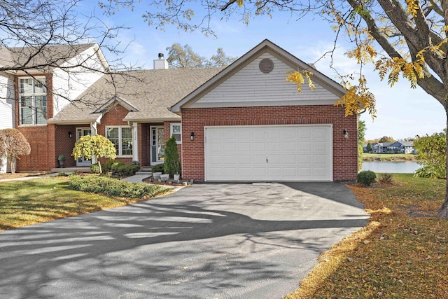 2708 Lake Shore Dr Unit 1, Joliet, IL 60431 - view of front facade with asphalt driveway, brick siding, a chimney, and a garage