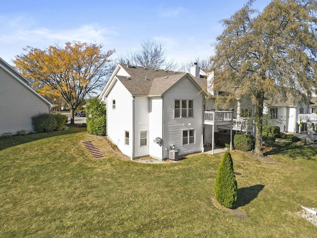 2708 Lake Shore Dr Unit 1, Joliet, IL 60431 - back of property with a chimney, a wooden deck, a yard, and central air condition unit