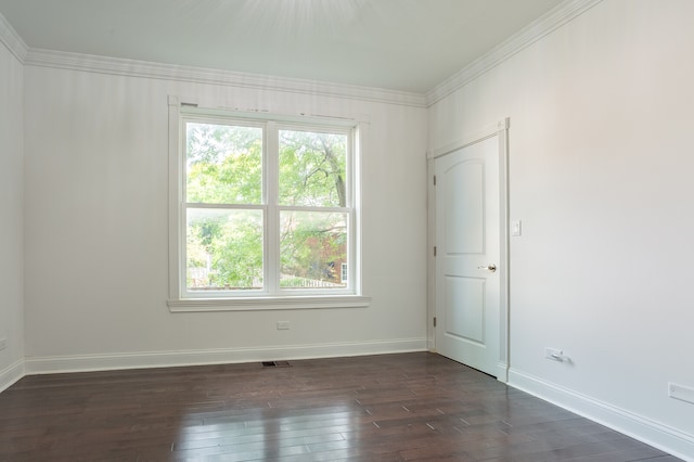 empty room featuring ornamental molding and dark hardwood / wood-style floors