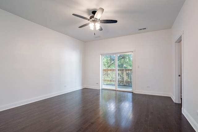 empty room featuring dark wood-type flooring and ceiling fan