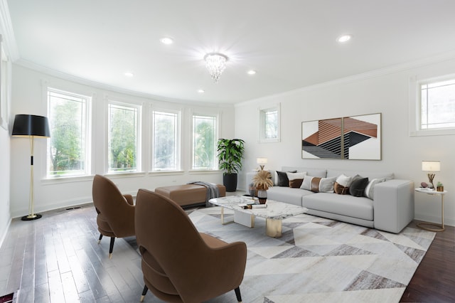 living room with light wood-type flooring, a chandelier, and ornamental molding