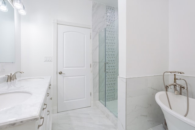 bathroom with tile walls, independent shower and bath, and vanity