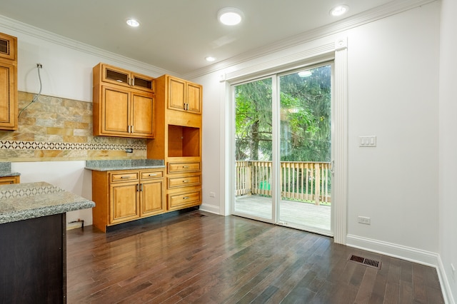 kitchen featuring ornamental molding, dark hardwood / wood-style flooring, and tasteful backsplash