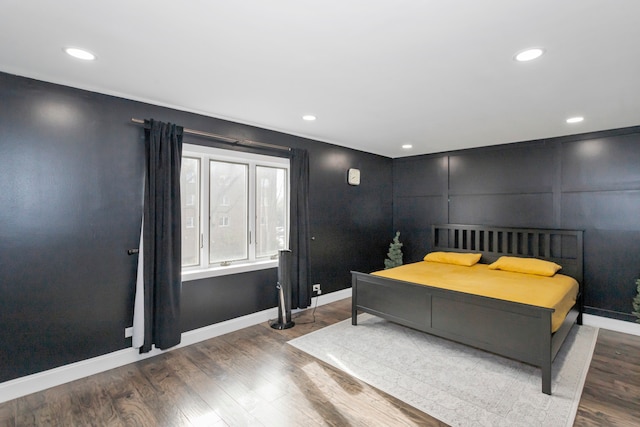 bedroom with dark hardwood / wood-style floors