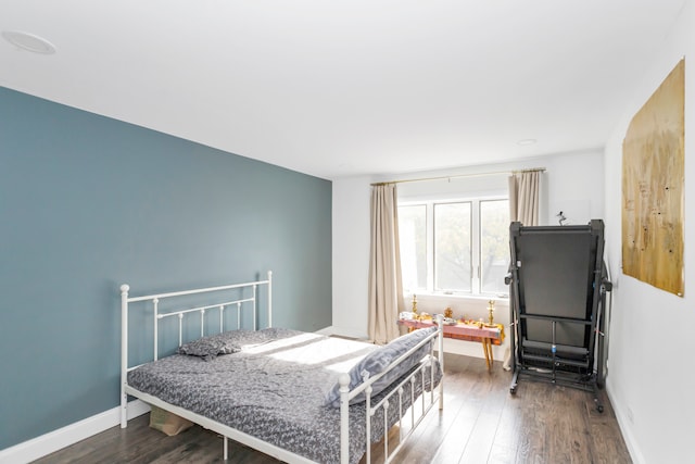 bedroom with dark wood-type flooring