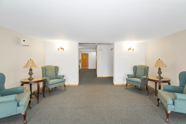 sitting room featuring dark carpet