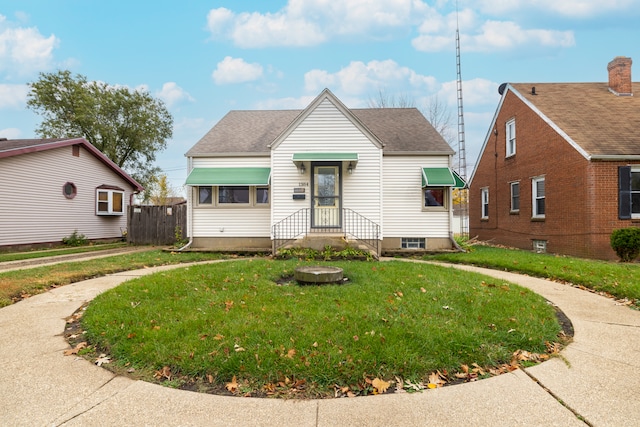 bungalow-style home with a front lawn