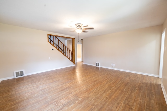 empty room with hardwood / wood-style flooring and ceiling fan