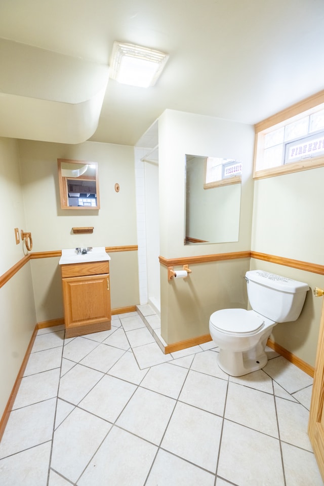 bathroom featuring vanity, tile patterned floors, and toilet