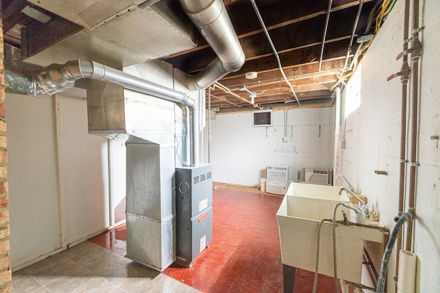 basement with heating unit and sink