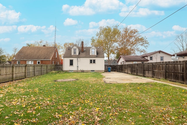 rear view of house featuring a patio and a yard