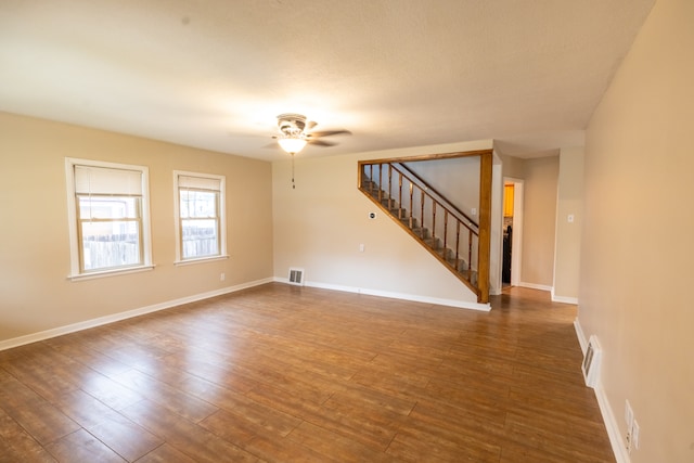 empty room featuring ceiling fan and dark hardwood / wood-style floors