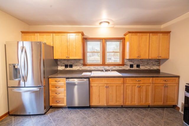 kitchen featuring backsplash, appliances with stainless steel finishes, and sink