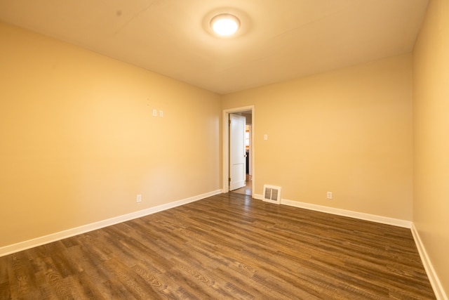 empty room with dark hardwood / wood-style floors