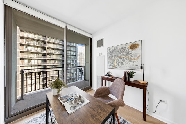 dining space with hardwood / wood-style flooring