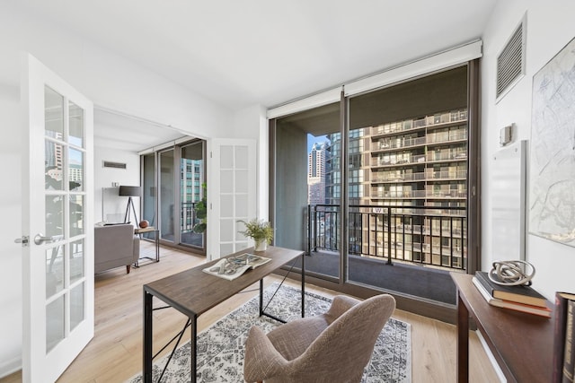 wine room featuring floor to ceiling windows, french doors, and hardwood / wood-style flooring