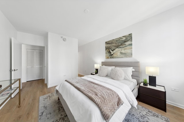 bedroom featuring light wood-type flooring and a closet