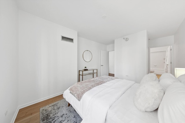 bedroom with hardwood / wood-style flooring