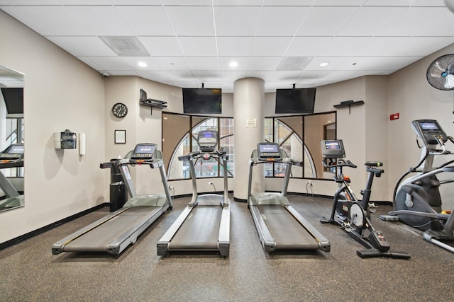 workout area featuring plenty of natural light and a drop ceiling