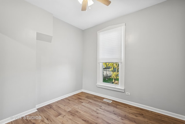 empty room featuring light wood-type flooring and ceiling fan