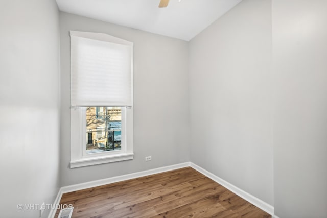 empty room with hardwood / wood-style flooring and ceiling fan