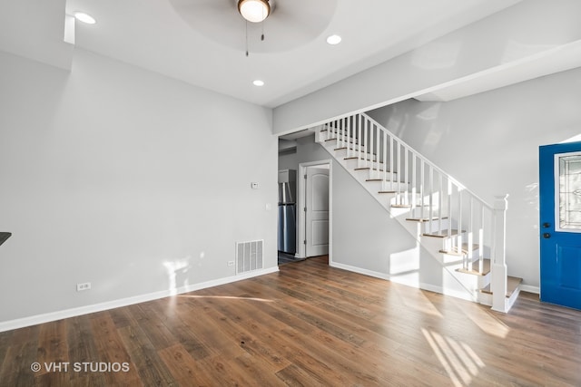 unfurnished living room with dark wood-type flooring and ceiling fan