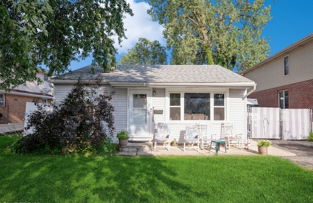 view of front facade featuring a front lawn and a patio area